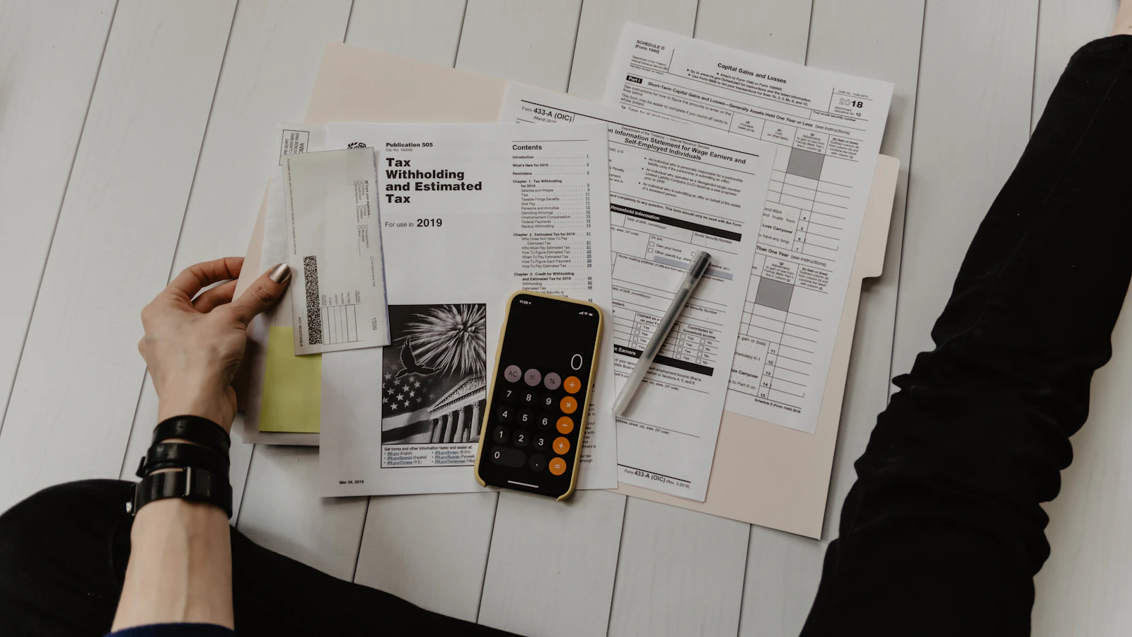 Paperwork, a pen and a calculator on a desk, representing earning money through skills
